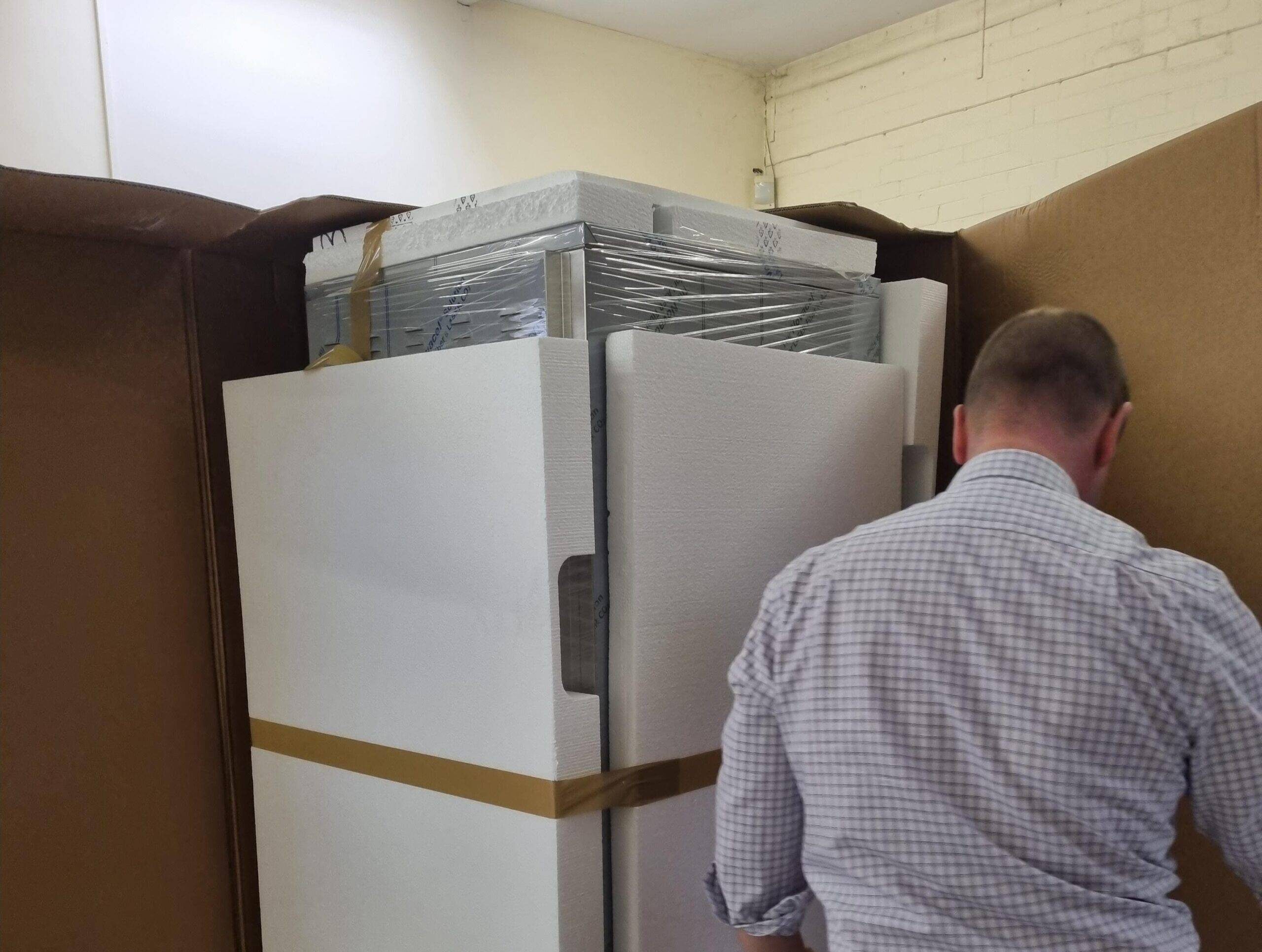 new miele aqueous cleaning system being unpackaged at fraser technologies